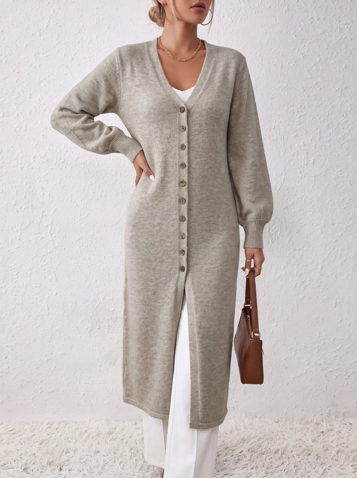 Woman wearing light grey long cardigan close up front view