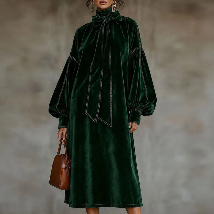 Woman wearing green velvet maxi dress with lantern sleeves