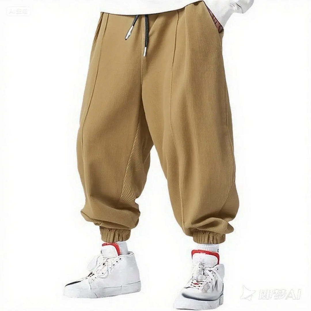 Man wearing khaki corduroy jogger pants with elastic cuffs