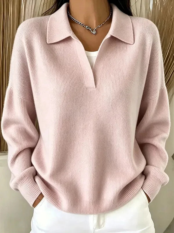 Woman wearing pink ribbed knit polo sweater with deep V neckline