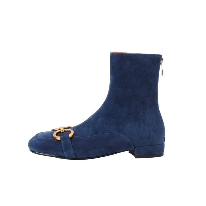 Blue suede ankle boot with gold horsebit buckle, side view