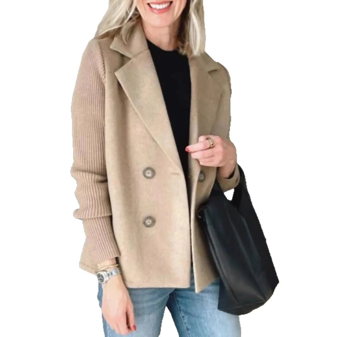 Woman wearing camel double-breasted blazer carrying a black bag