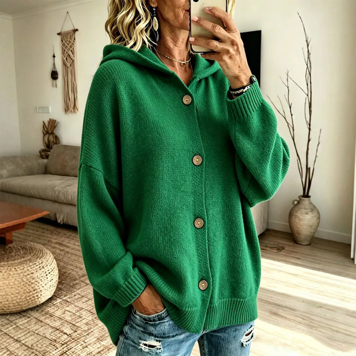 Woman wearing green hooded knit cardigan with button front