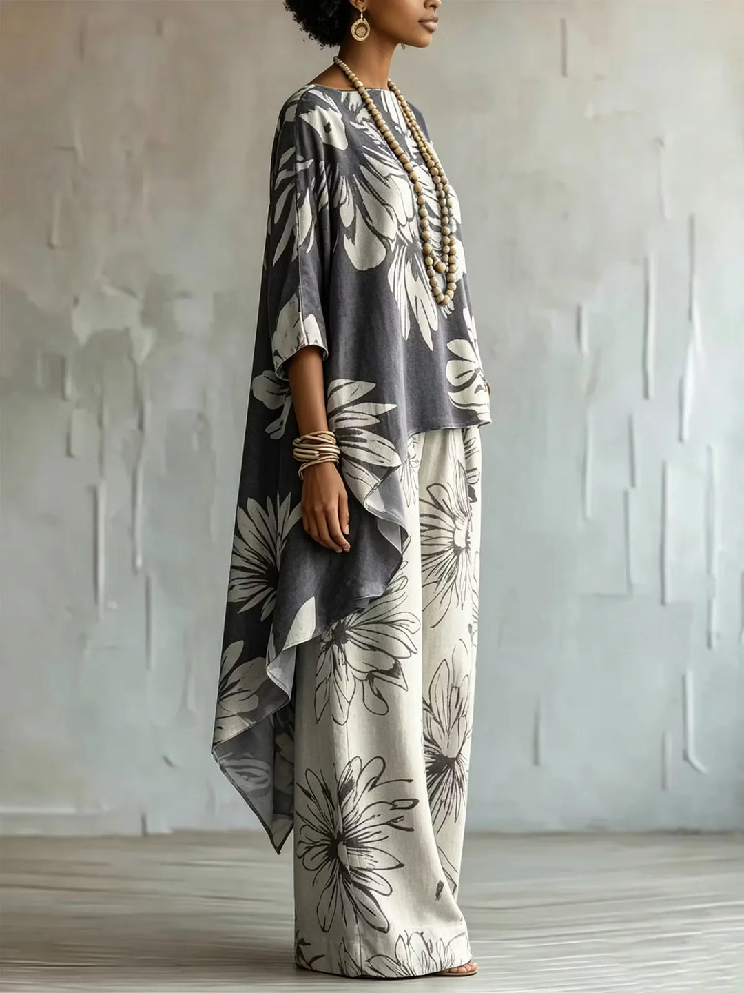 Side view of gray floral two-piece set with asymmetric top and wide leg pants