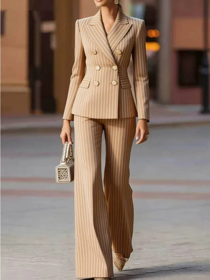 Woman wearing beige pinstripe double-breasted pant suit walking outdoors