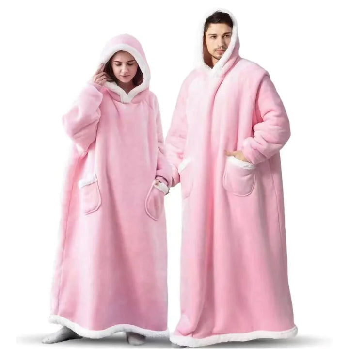 Man and woman wearing pink hooded wearable blankets