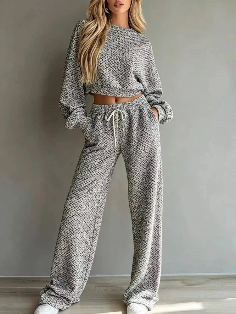 Woman wearing grey textured knit cropped top and wide leg pants set