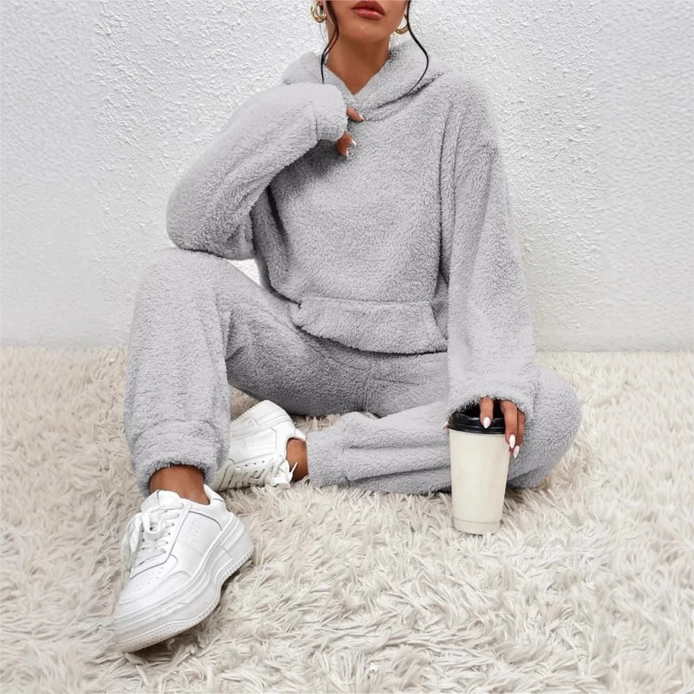 Woman wearing gray brushed fleece hooded loungewear set holding coffee