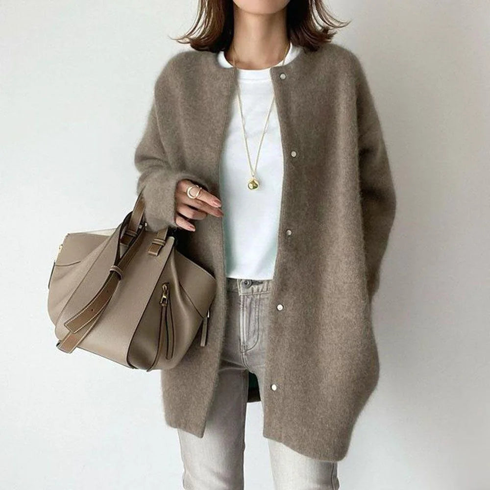 Woman wearing taupe oversized knit cardigan with snap button front