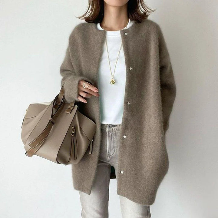 Woman wearing taupe oversized knit cardigan with snap button front