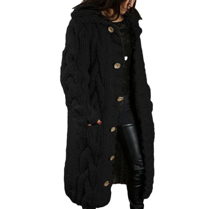 Woman wearing black hooded cable knit long cardigan, front angle