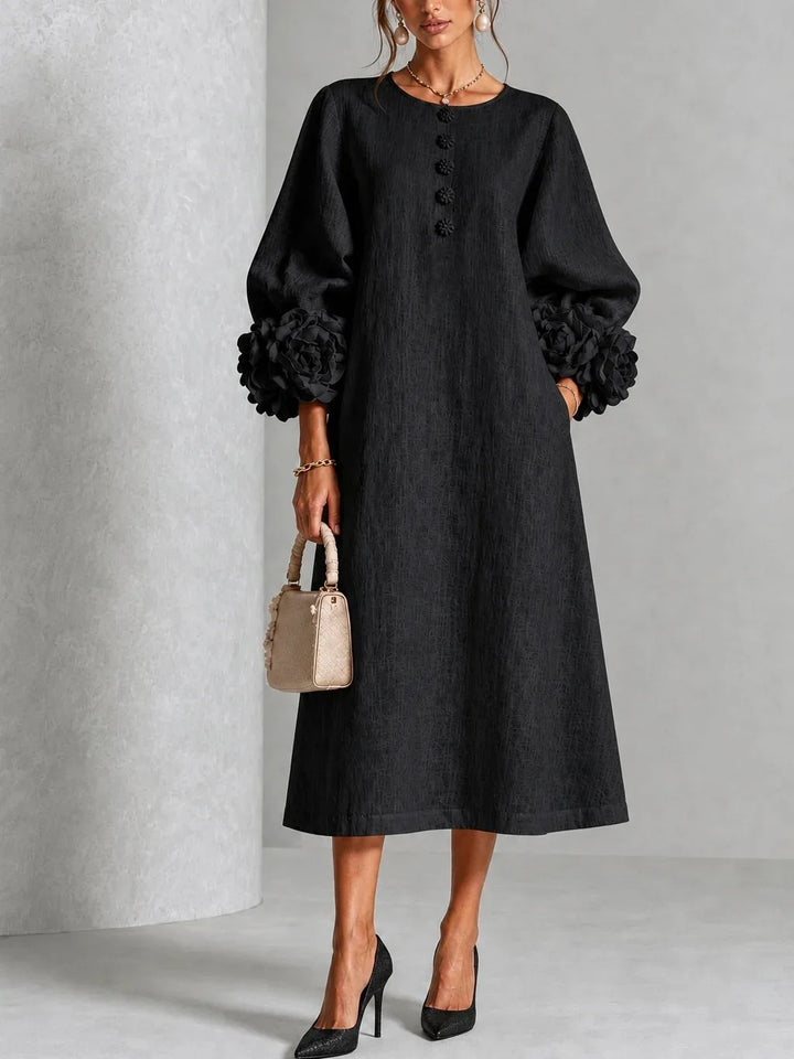 Woman wearing black midi dress with 3D floral lantern sleeve cuffs