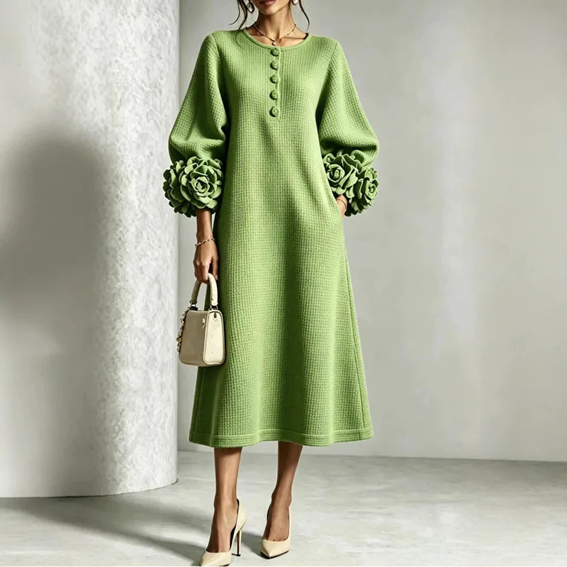 Woman wearing green knit midi dress with floral cuffs