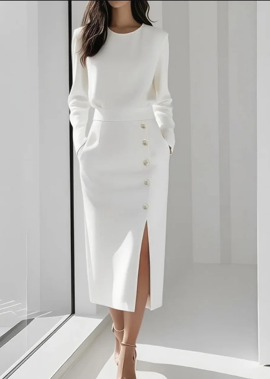 White midi dress with button detail and side slit, styled with heels, full length view