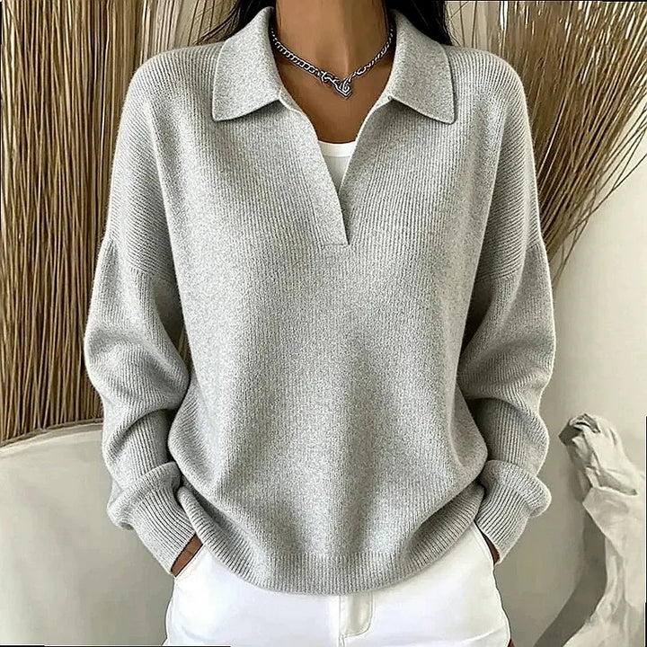 Woman wearing silver gray ribbed knit polo sweater with deep V neckline