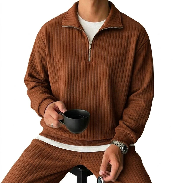 Man wearing brown ribbed quarter-zip pullover, front view