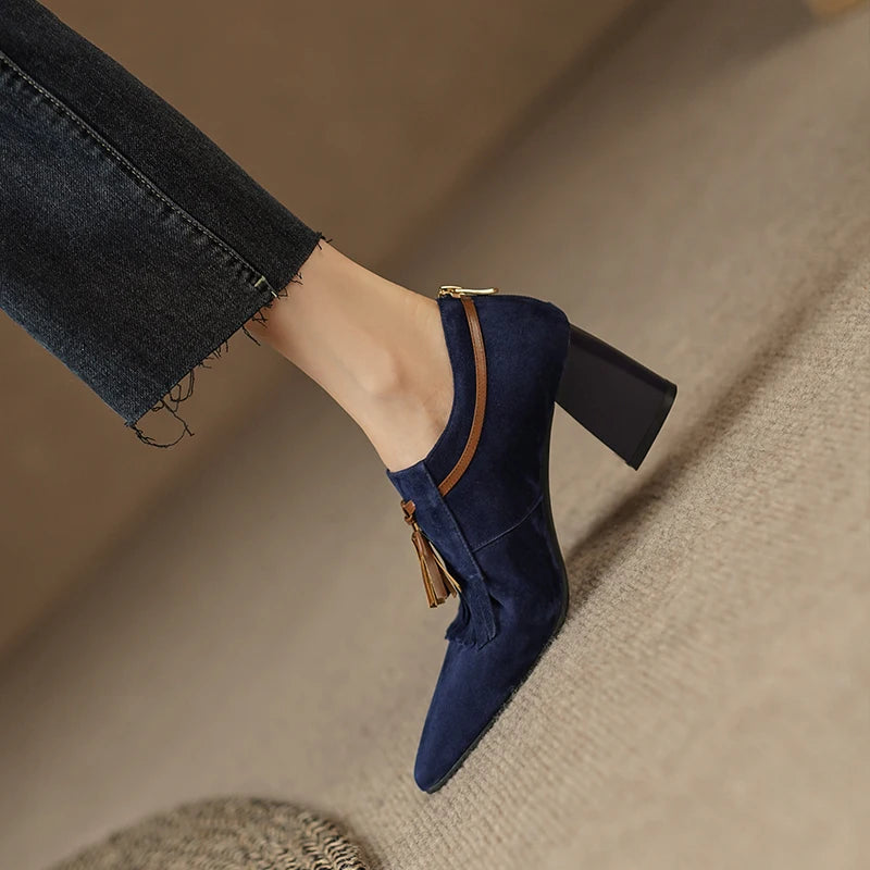 Side profile of navy suede pump showing block heel and zip closure