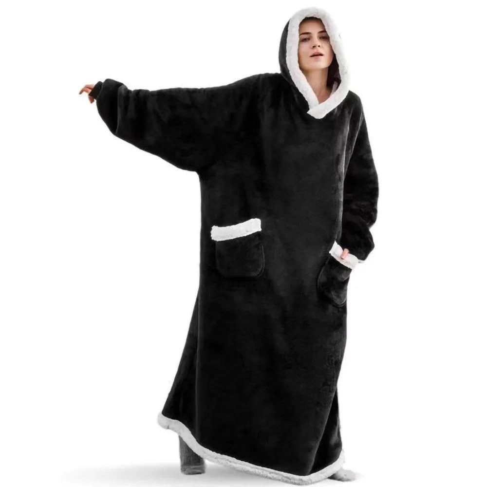 Woman wearing black hooded wearable blanket with front pockets