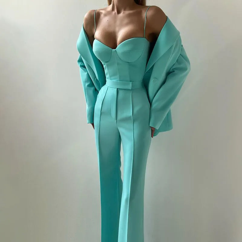 Emerald bustier top and flared trousers with blazer worn off shoulder