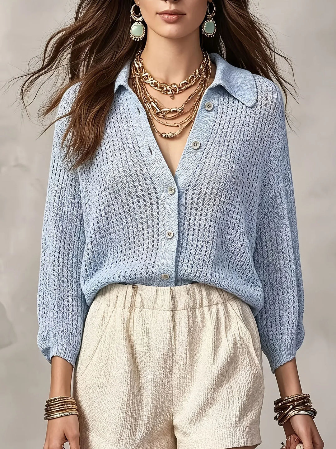 Woman wearing light blue open crochet knit cardigan with collar and buttons, front view