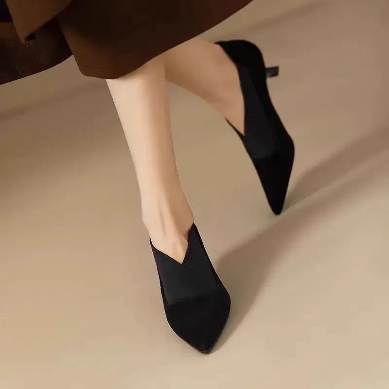 Black suede pointed toe kitten heel pump on model in motion