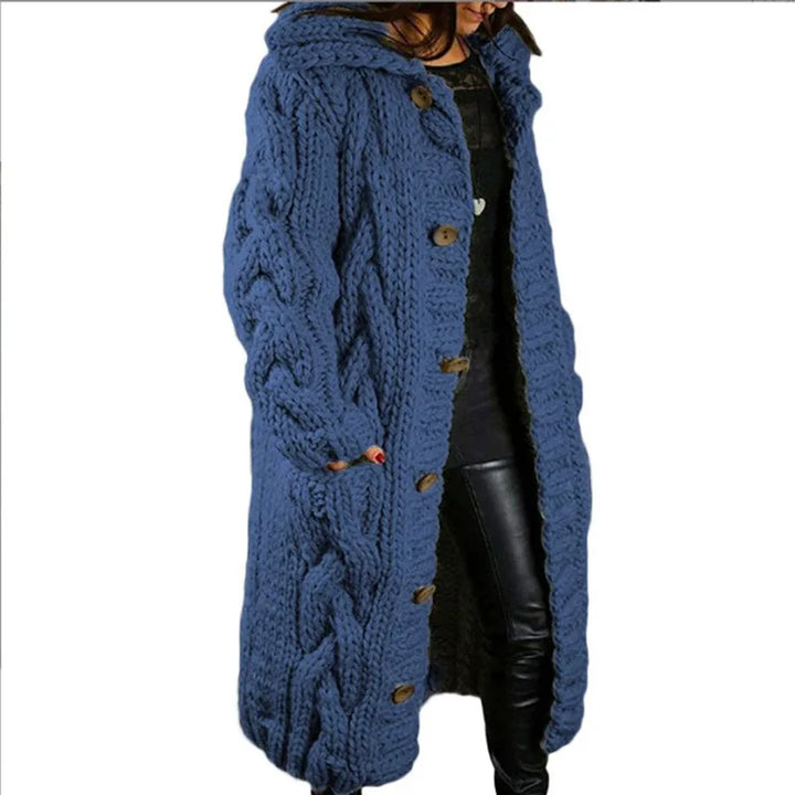 Woman wearing blue hooded cable knit long cardigan, front angle