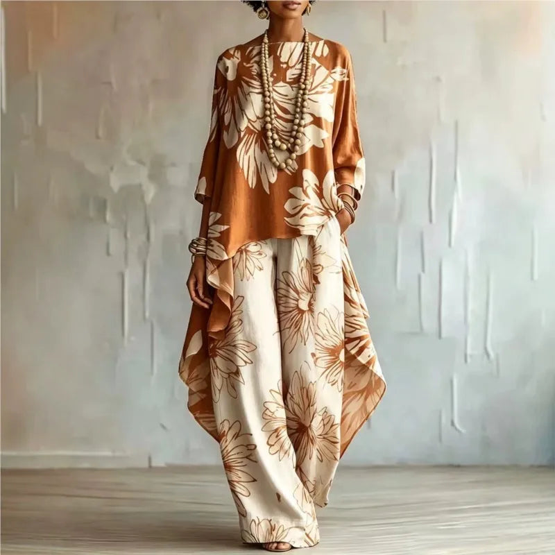Woman wearing orange floral two-piece set with asymmetric top and wide leg pants