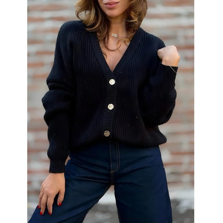 Woman wearing black ribbed knit button front cardigan