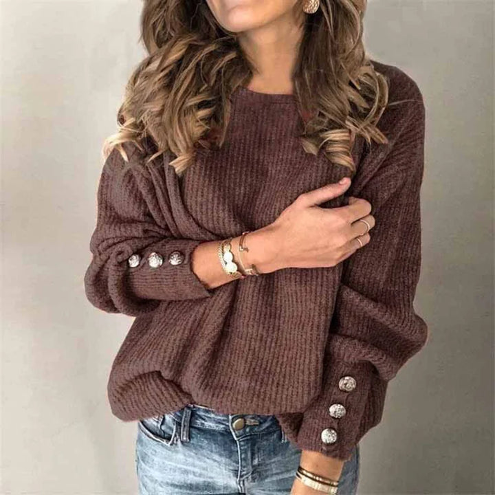 Woman wearing brown ribbed knit sweater with button cuffs, front view