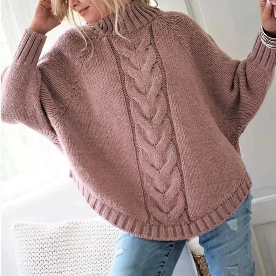 Woman wearing pink cable knit oversized sweater with raised arms