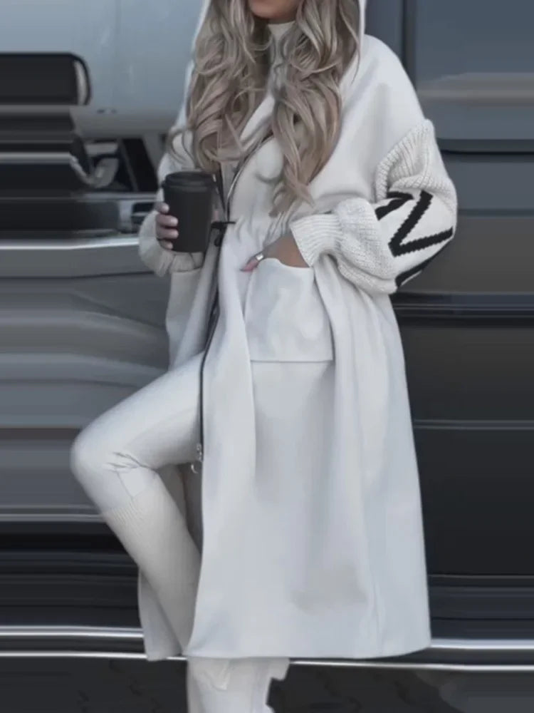 Side view of white hooded maxi coat with contrast knit sleeve