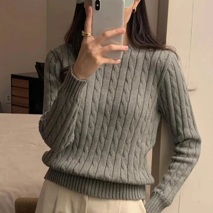 Gray cable knit crew neck sweater on model