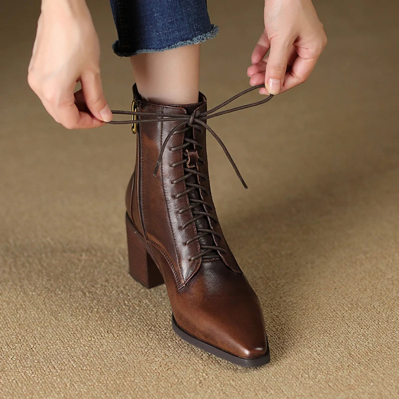 Model lacing up brown leather ankle boot