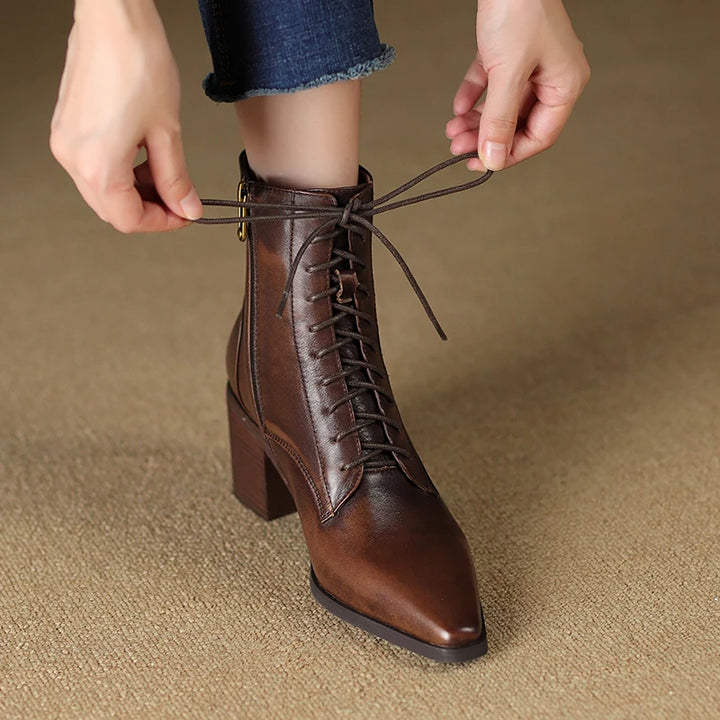 Model lacing up brown leather ankle boot