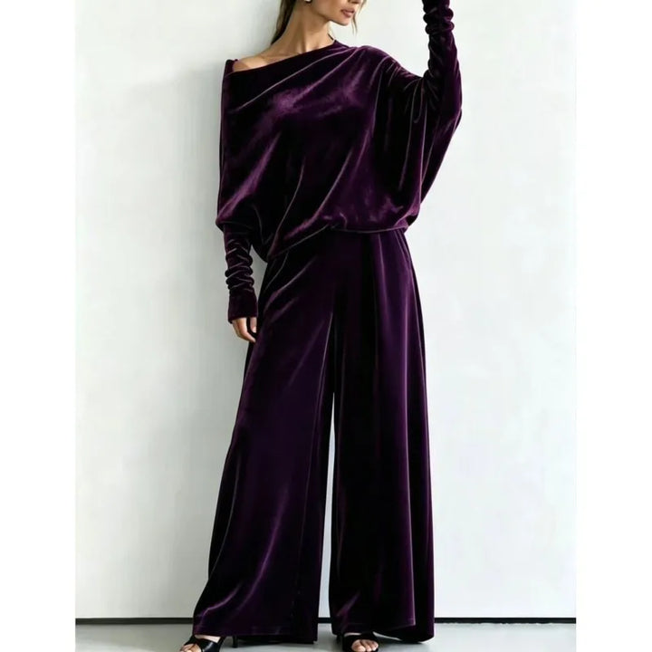 Woman wearing purple velvet off-shoulder top and wide leg pants set