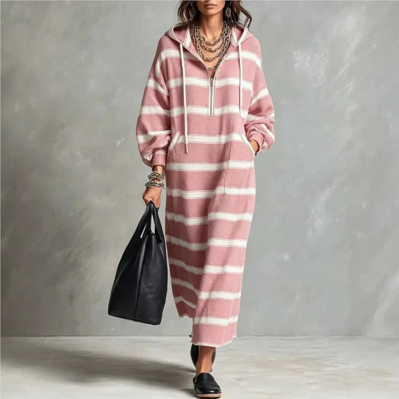 Woman walking in pink and white striped half-zip hoodie maxi dress