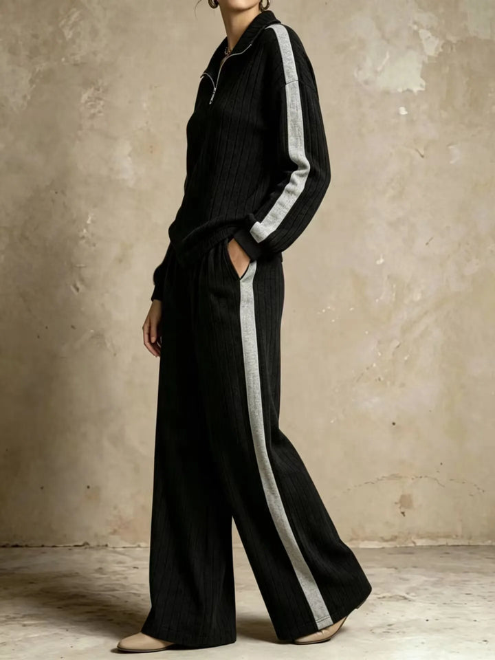Side view of black ribbed knit two piece set with gray side stripe
