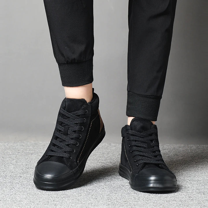 Model wearing black high-top sneakers front view