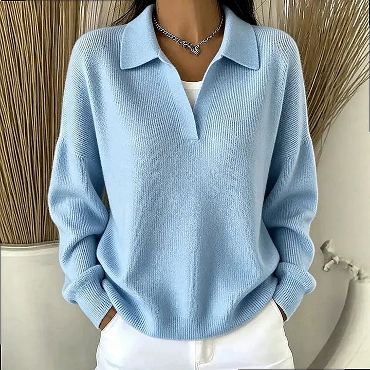 Woman wearing light blue ribbed knit polo sweater with deep V neckline