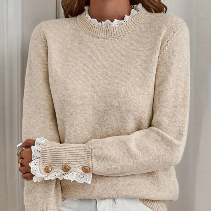 Close up of beige sweater lace collar and button cuff