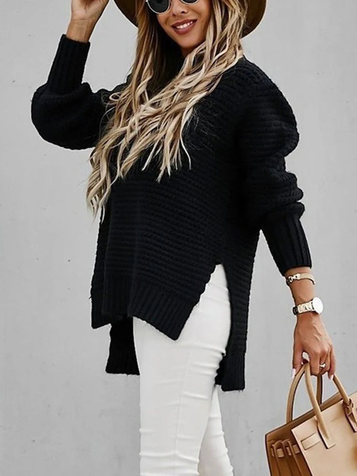 Side view of black chunky knit sweater with high low hem