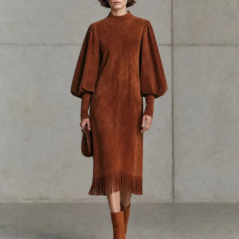 Woman wearing brown velvet lantern sleeve dress with fringe hem, front view