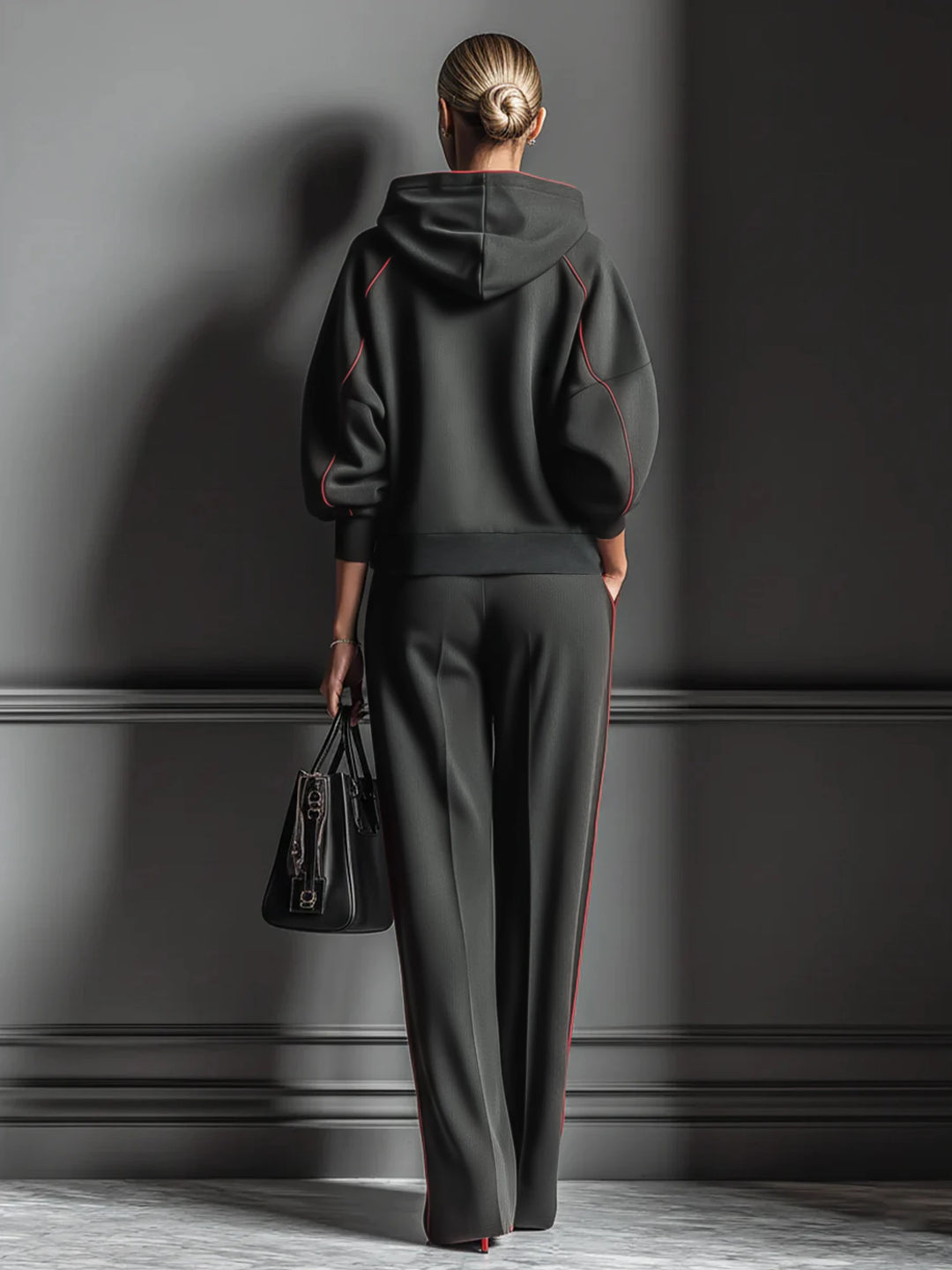 Back view of black hoodie and wide leg pants set with red piping