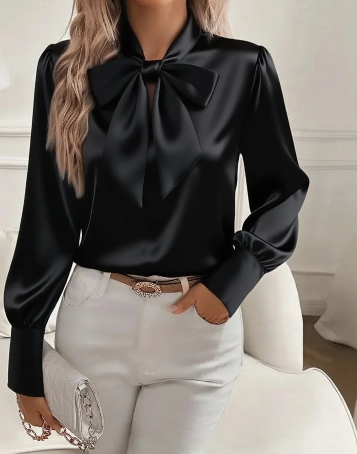 Woman wearing black satin bow tie collar blouse
