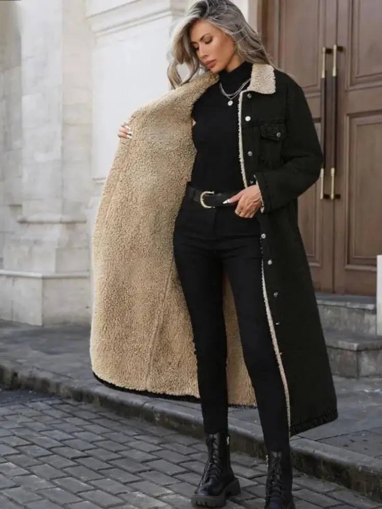 Woman wearing black denim long coat with sherpa collar, front view