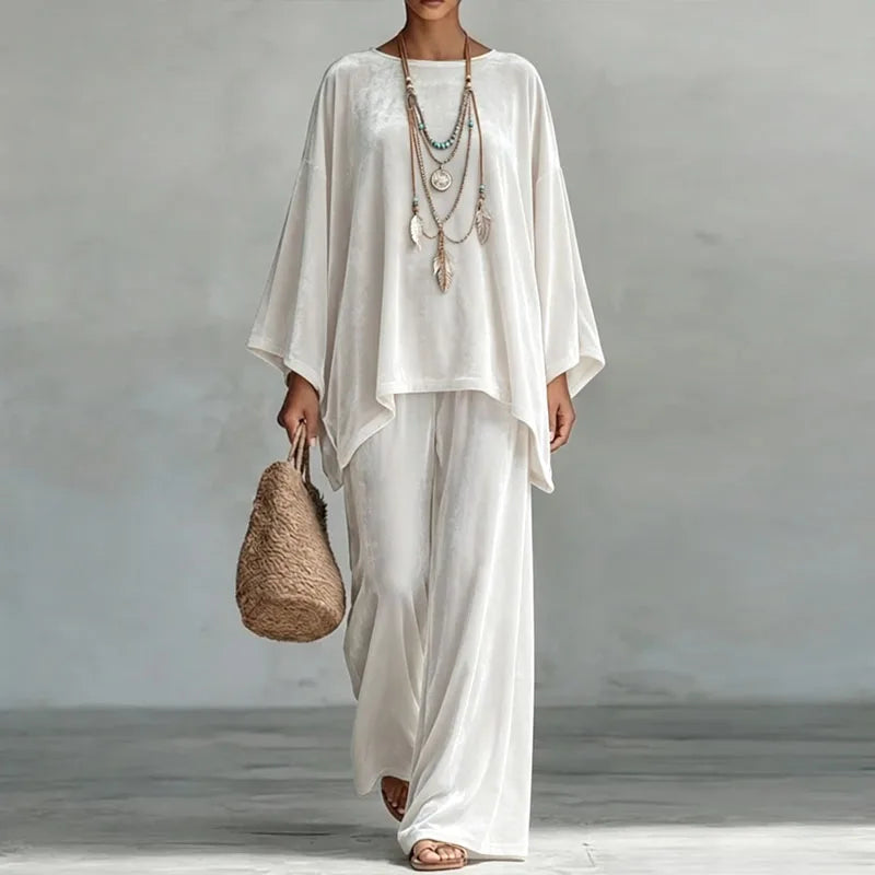 Woman wearing white velvet batwing top and wide leg pants set, front view