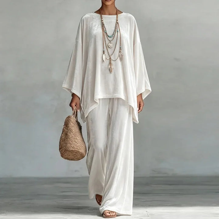 Woman wearing white velvet batwing top and wide leg pants set, front view