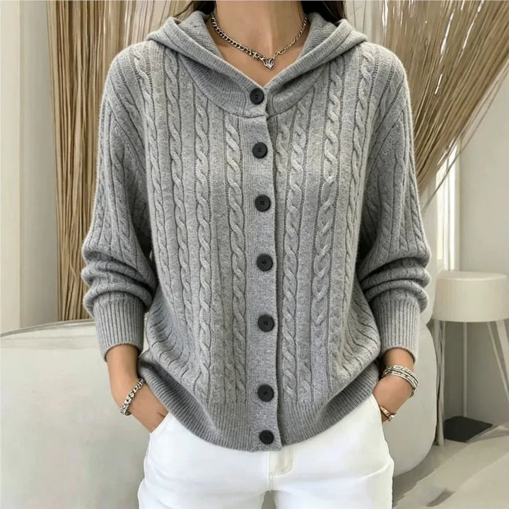 Woman wearing gray cable knit hooded cardigan with button front