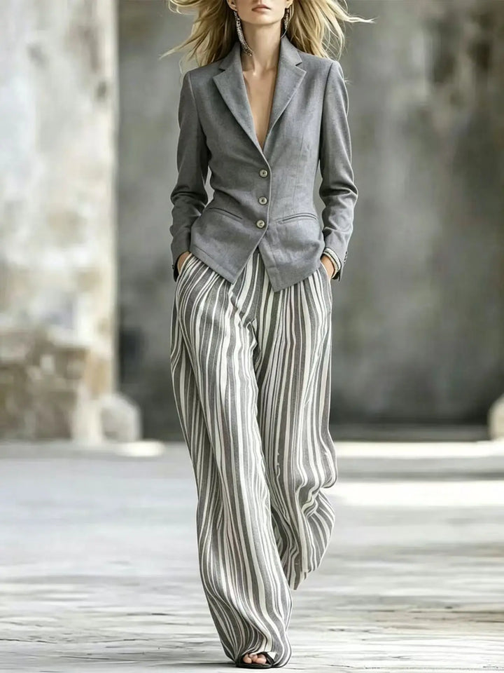 Woman wearing gray blazer with striped wide leg pants suit