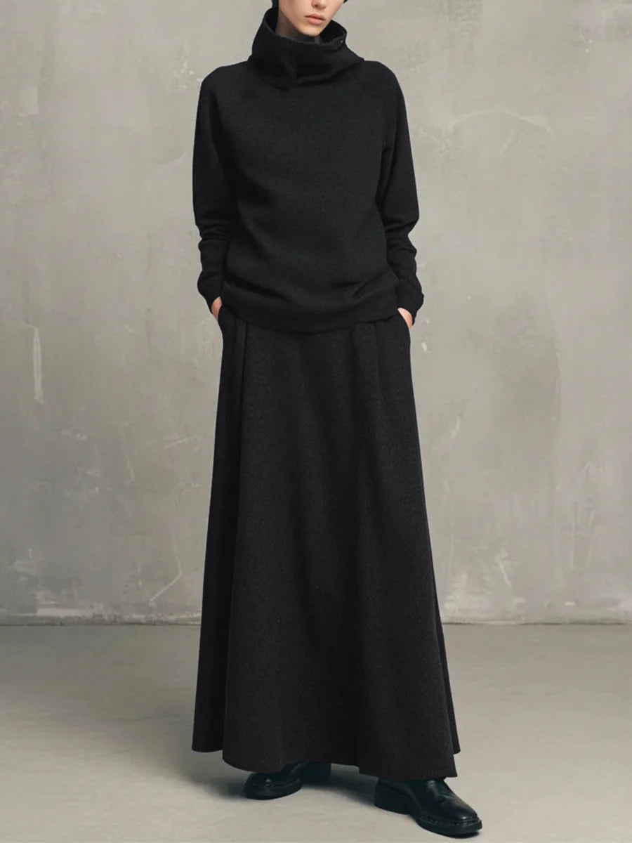 Woman wearing black funnel neck sweatshirt and matching maxi skirt set